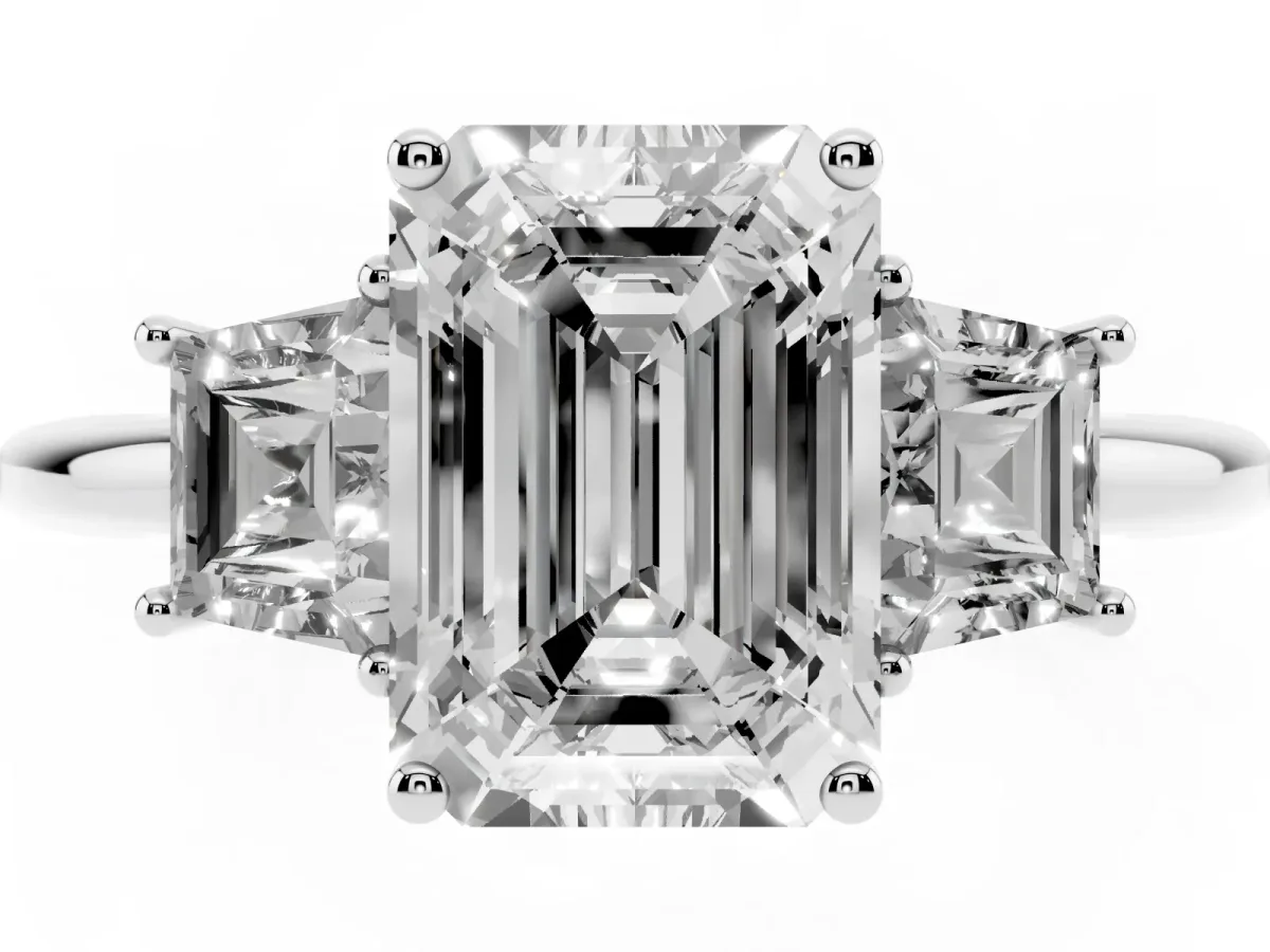Emerald Cut Diamond Three-Stone Ring with Trapezoid Side Stones and Prong Setting White gold