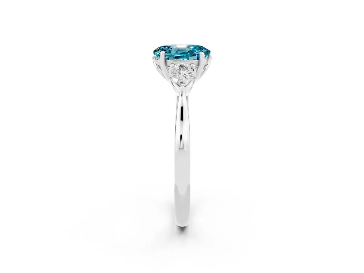 Three-Stone Oval Cut Blue Topaz Ring with Pear Side Stones in Four-Prong Setting White gold