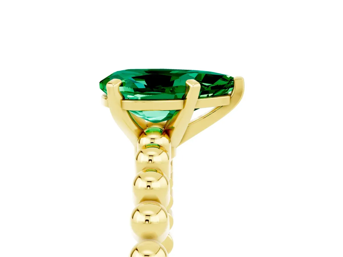 Pear Cut Emerald Solitaire Ring with Beaded Band and Prong Setting Yellow gold