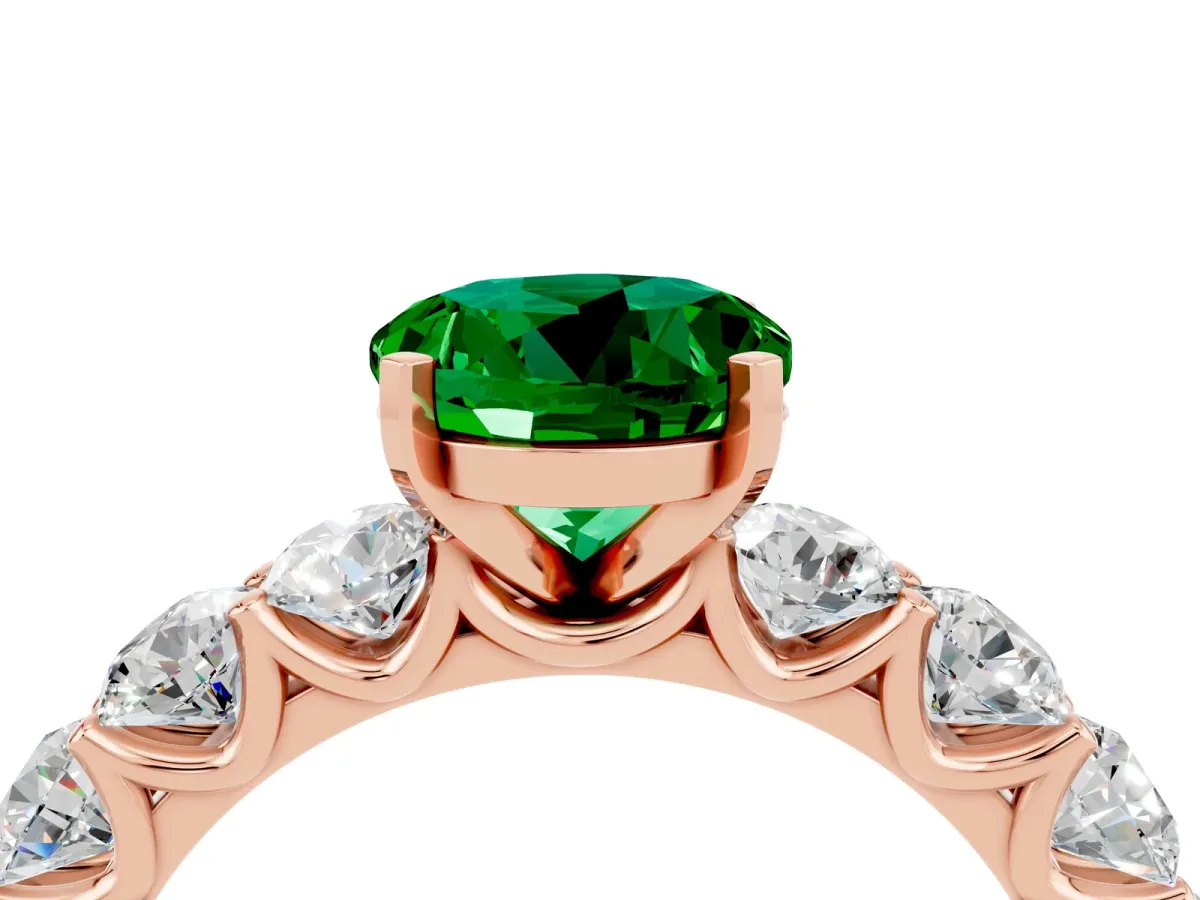 Round Cut Emerald Prong Setting with Side Stones on a Pave Band Rose gold