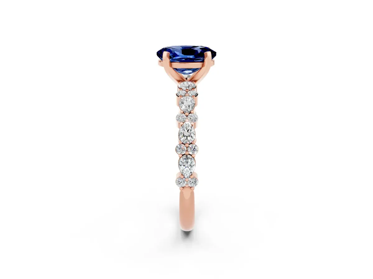 Oval Cut Blue Sapphire Side Stone Solitaire Ring with Round and Four-Prong Setting Rose gold
