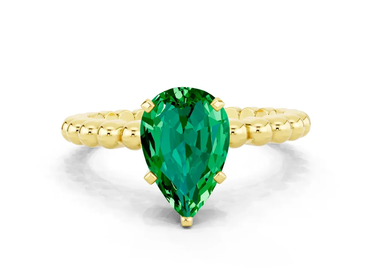Pear Cut Emerald Solitaire Ring with Beaded Band and Prong Setting Yellow gold