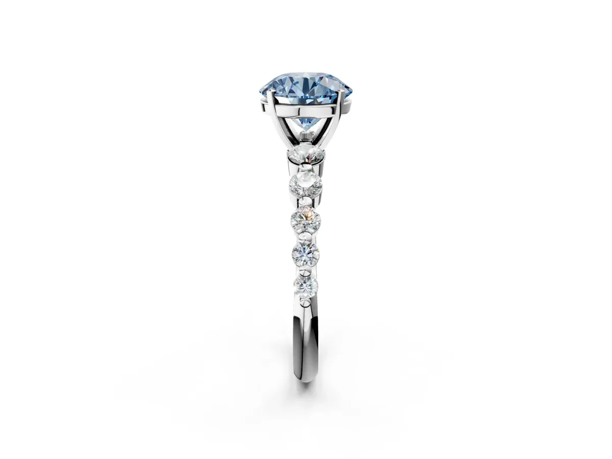 Fancy Blue Round Cut Solitaire Diamond Ring with Pave Band and Four-Prong Setting Silver