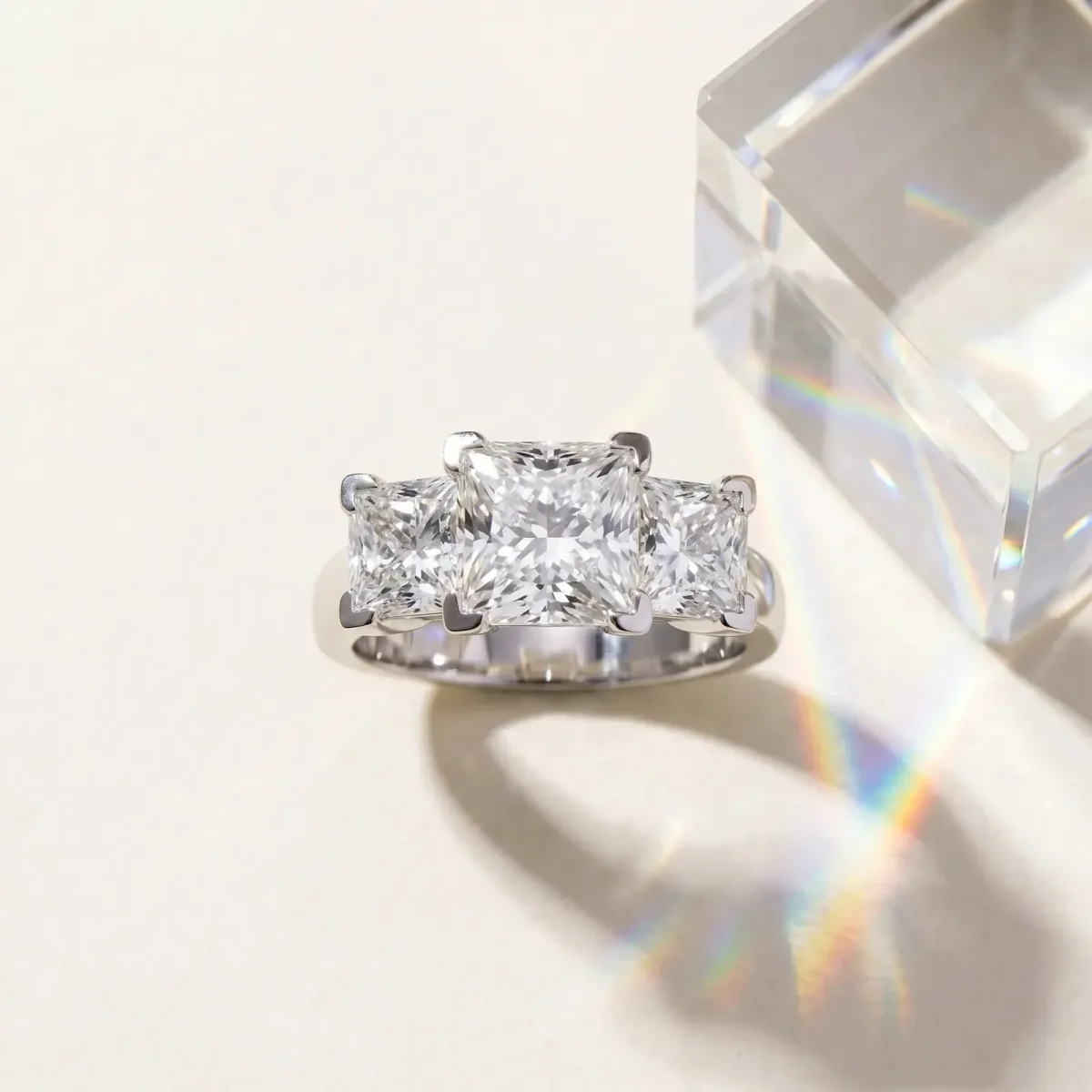 Three-Stone Radiant Cut Cut Diamond Ring with Channel Set Band and Four-Prong Setting Silver
