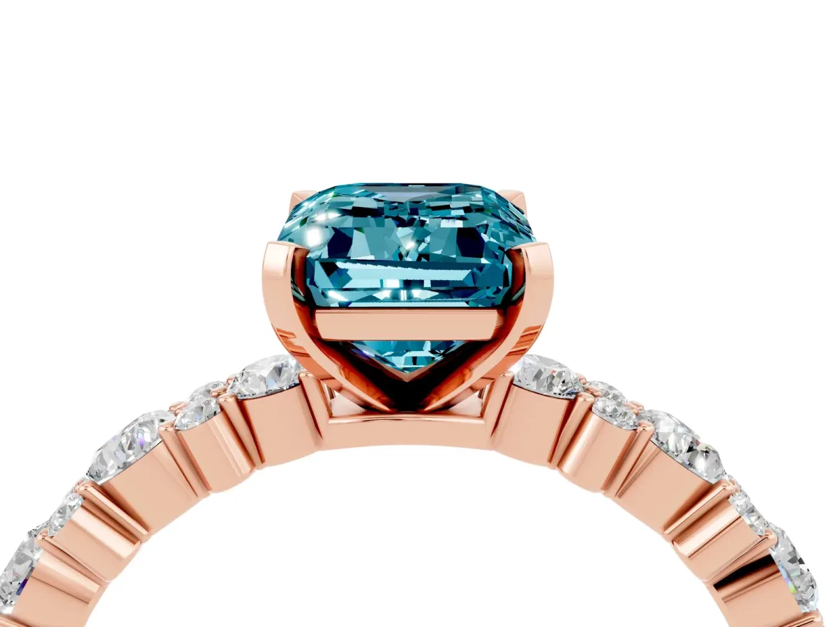 Emerald Cut Blue Topaz Side Stone Solitaire Ring with Round and Four-Prong Setting Rose gold