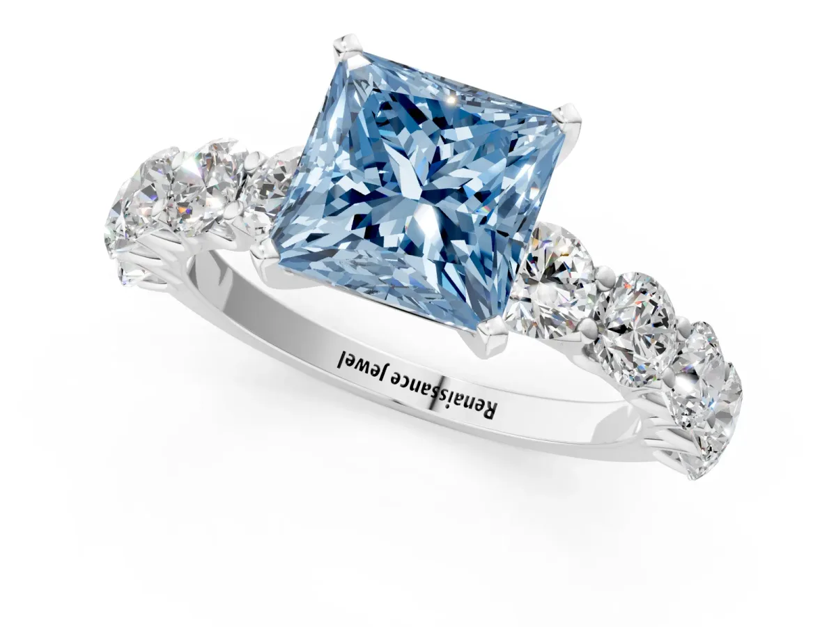Fancy Blue Princess Cut Diamond Prong Setting with Side Stones on a Pave Band Silver
