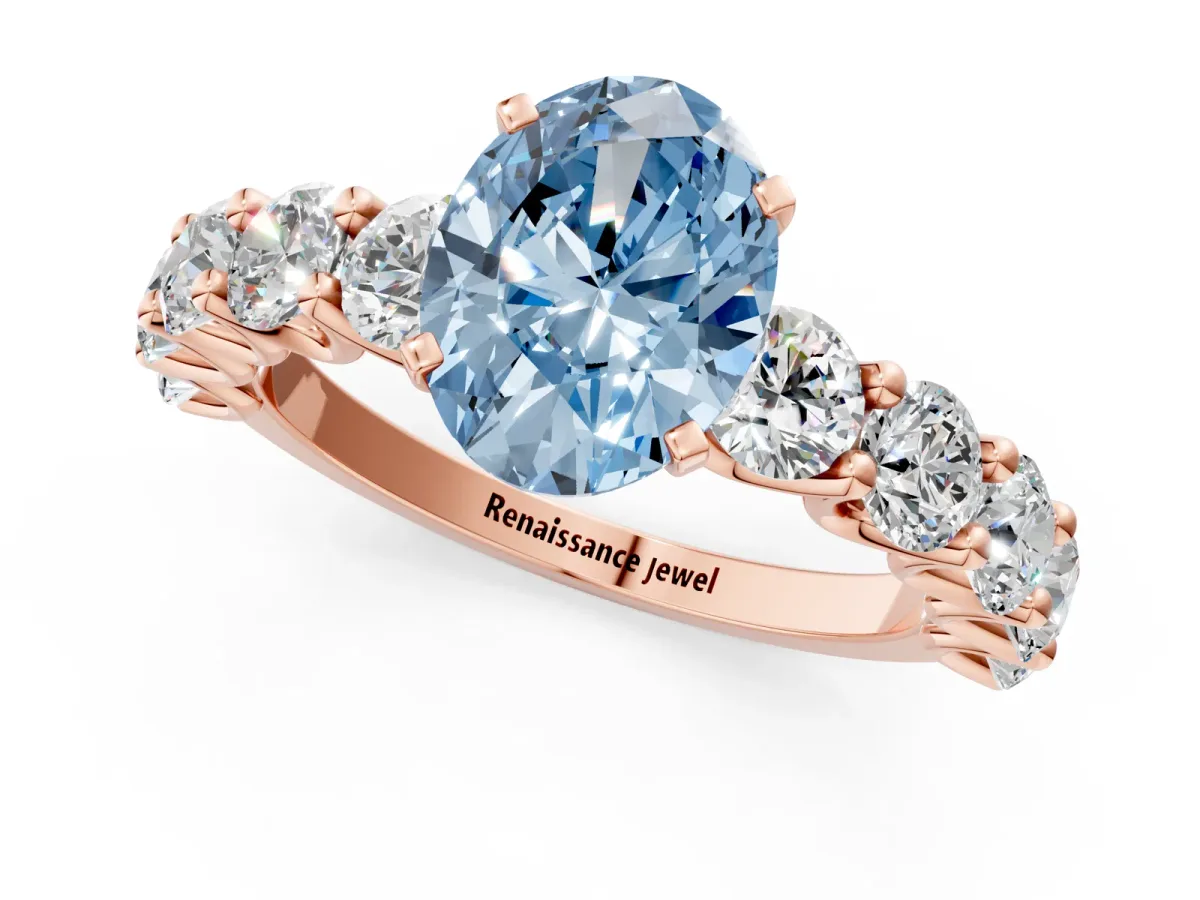 Fancy Blue Oval Cut Diamond Prong Setting with Side Stones on a Pave Band Rose gold