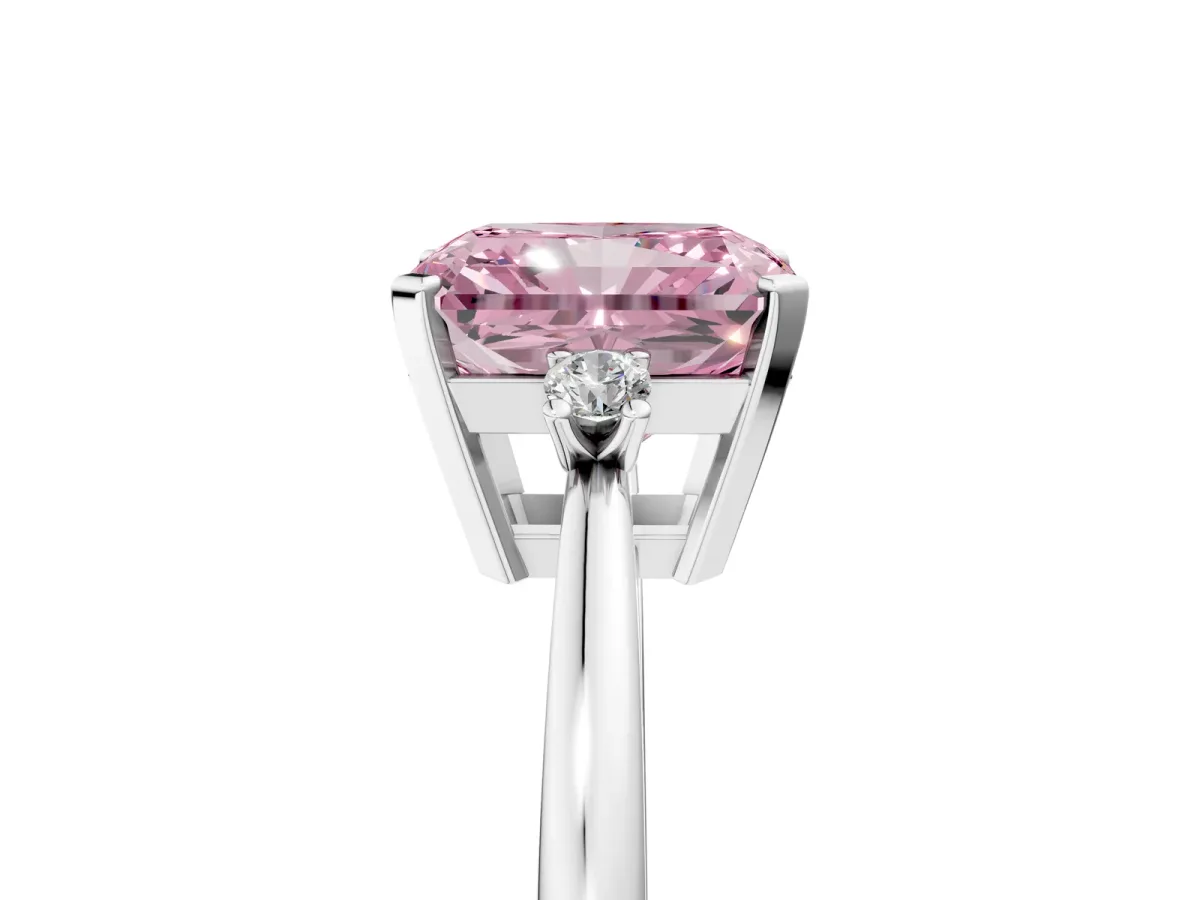Fancy Pink Radiant Cut Cut Three-Stone Solitaire Ring with Round Accent Diamonds and Four-Prong Setting Platinum