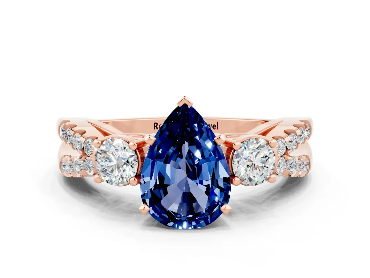Pear Cut Blue Sapphire Three-Stone Ring with Pavé Split Shank and Four-Prong Setting Rose gold