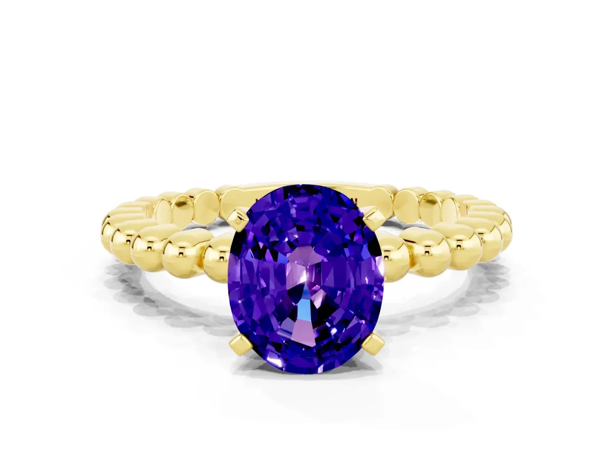 Oval Cut Tanzanite Solitaire Ring with Beaded Band and Prong Setting Yellow gold