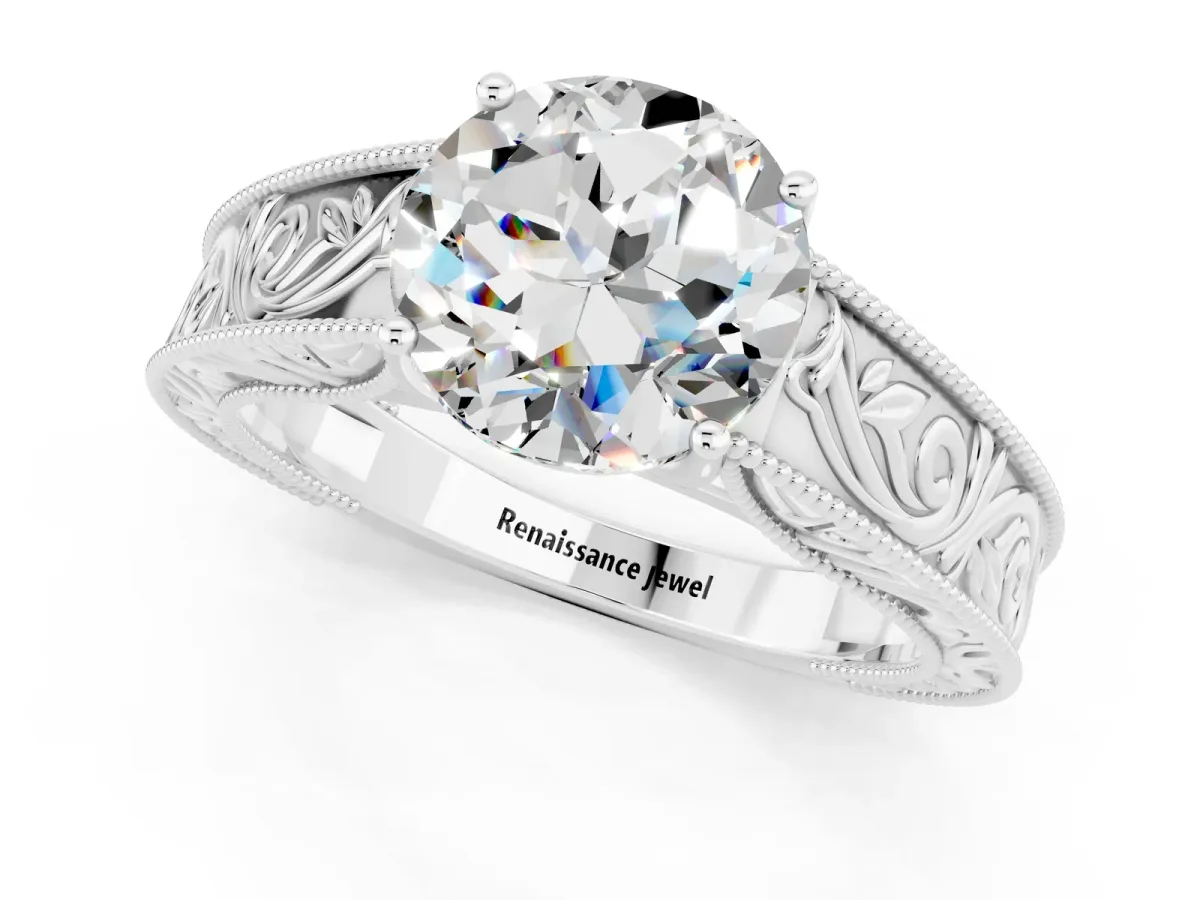 Round Cut Moissanite Solitaire Ring with Engraved Band and Four-Prong Setting White gold