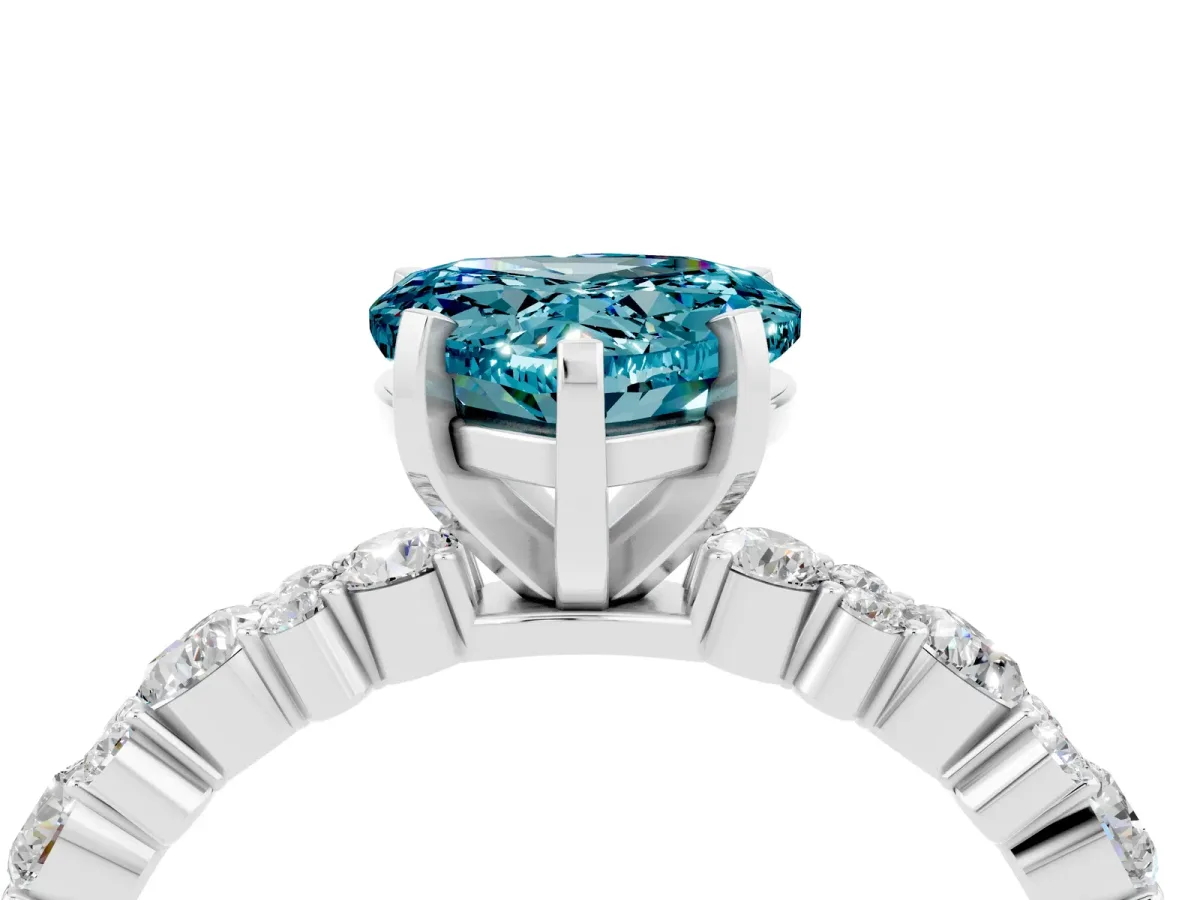 Heart Cut Blue Topaz Side Stone Solitaire Ring with Round and Four-Prong Setting Silver