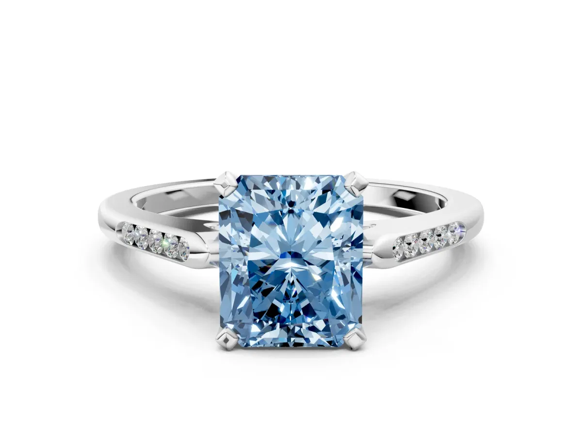 Fancy Blue Radiant Cut Diamond Solitaire Ring with Channel Set Round Band and Prong Setting Silver