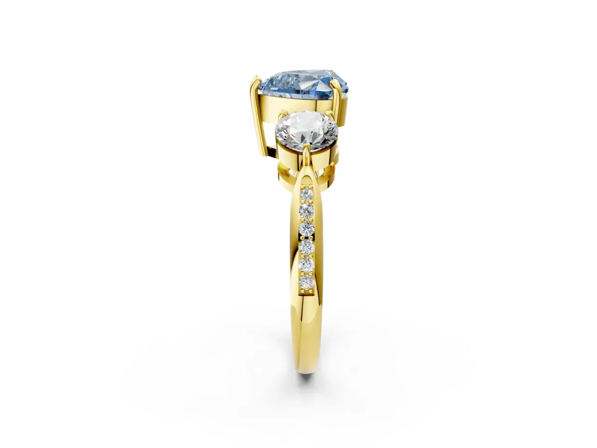 Fancy Blue Three-Stone Heart Cut Diamond Channel Set Engagement Ring with Prong Setting Yellow gold