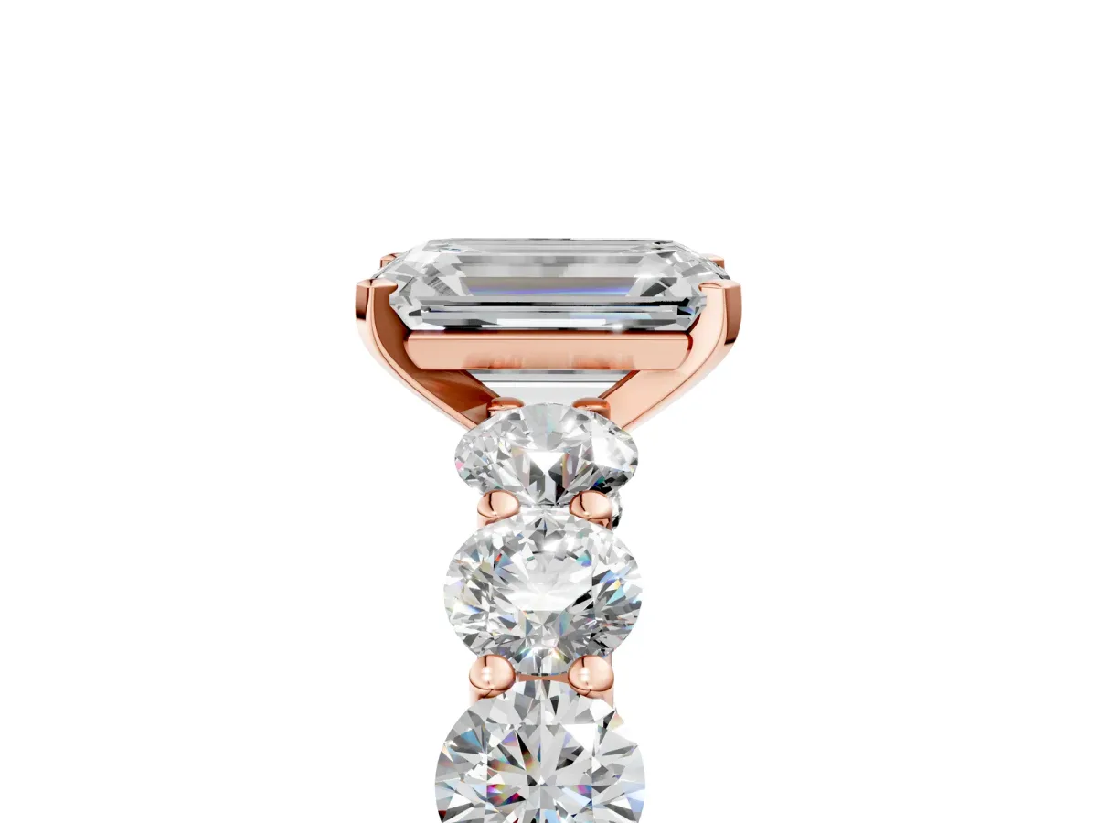 Emerald Cut Diamond Prong Setting with Side Stones on a Pave Band Rose gold