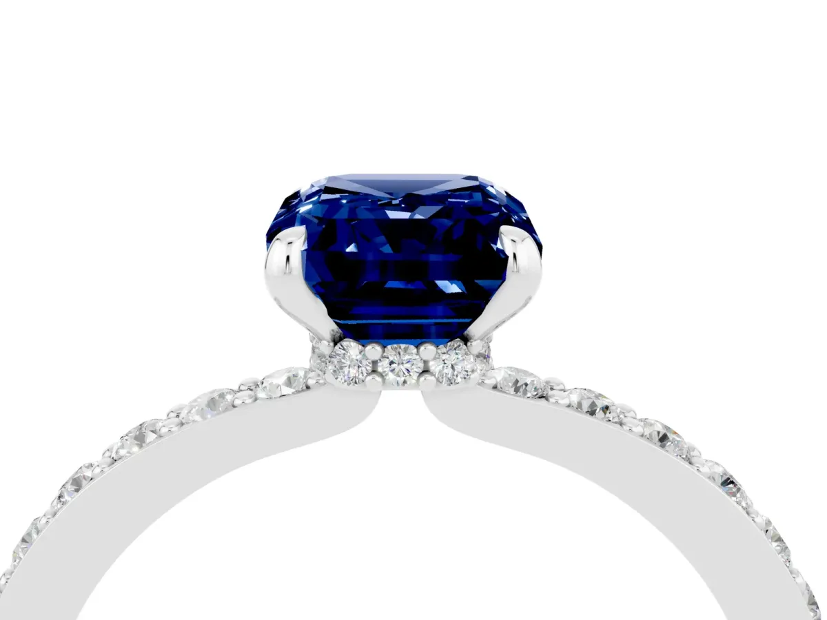Emerald Cut Blue Sapphire Solitaire Engagement Ring with Pavé Band and Four-Prong Setting Silver