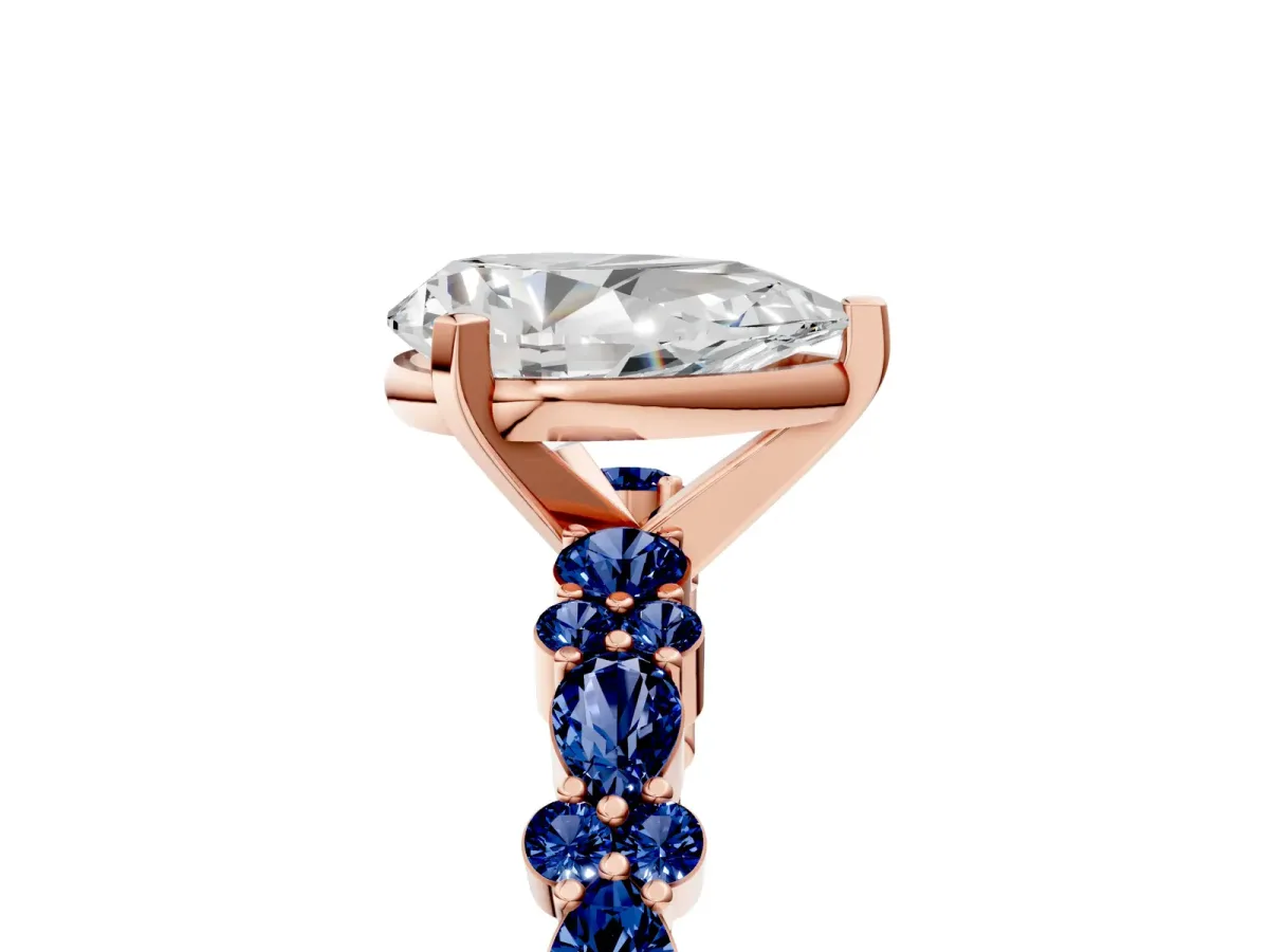 Pear Cut Diamond Side Stone Solitaire Ring with Round Blue Sapphire and Four-Prong Setting Rose gold
