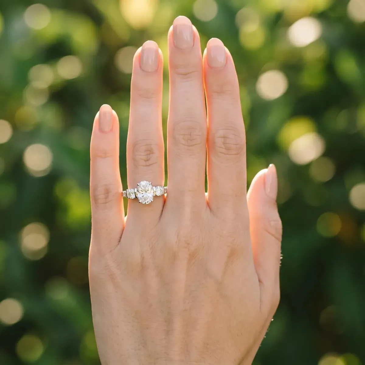 Oval Cut Brilliant Trilogy Channel Set Diamond Ring with Bar Prongs Platinum