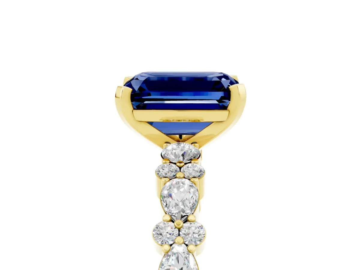 Emerald Cut Blue Sapphire Side Stone Solitaire Ring with Round and Four-Prong Setting Yellow gold