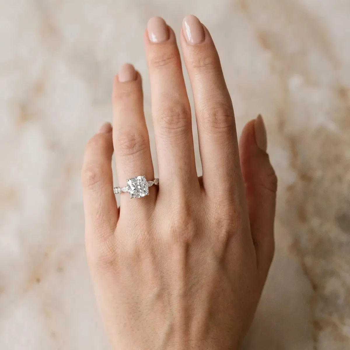 Cushion Cut Diamond Ring with Marquise and Round Side Stones and Four-Prong Setting Silver