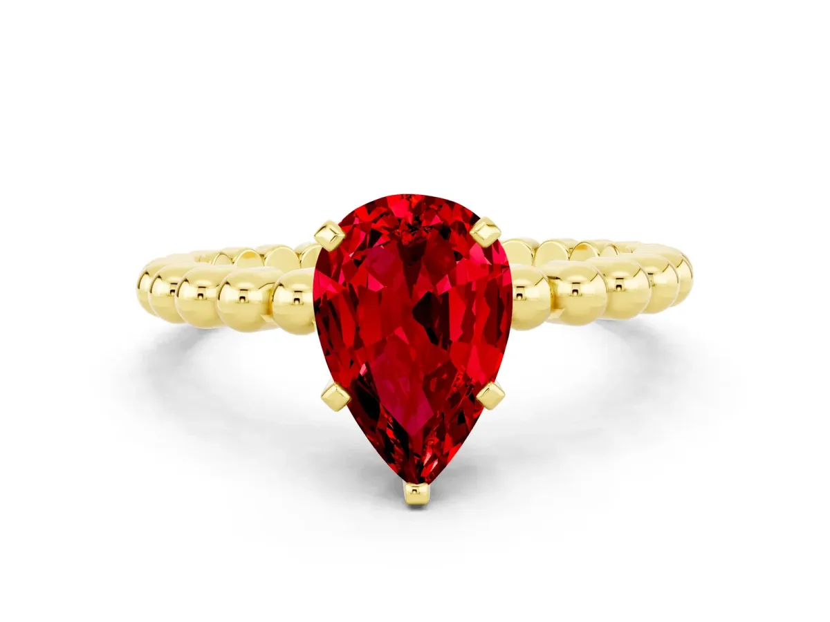 Pear Cut Ruby Solitaire Ring with Beaded Band and Prong Setting Yellow gold