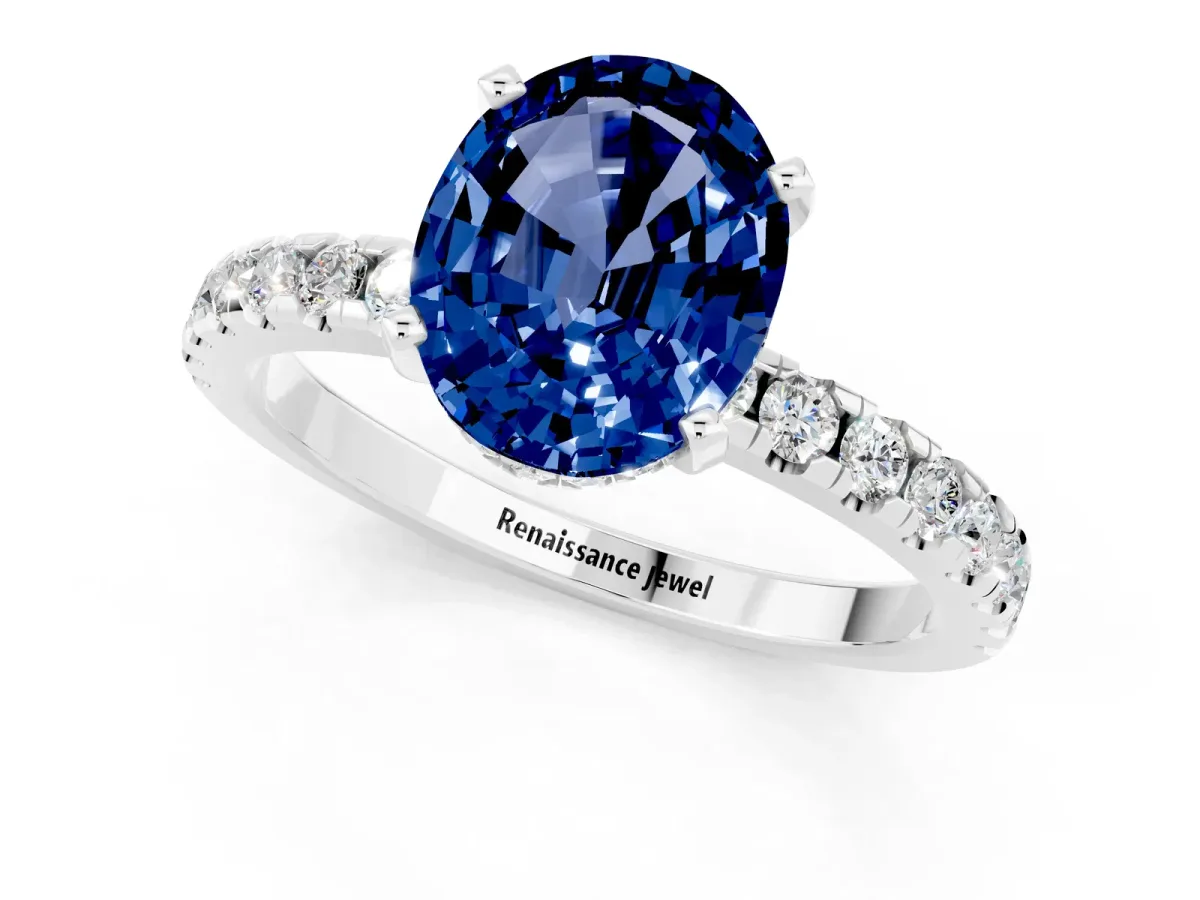 Oval Cut Blue Sapphire Solitaire Ring with Round Pavé Band and Four-Prong Setting Silver