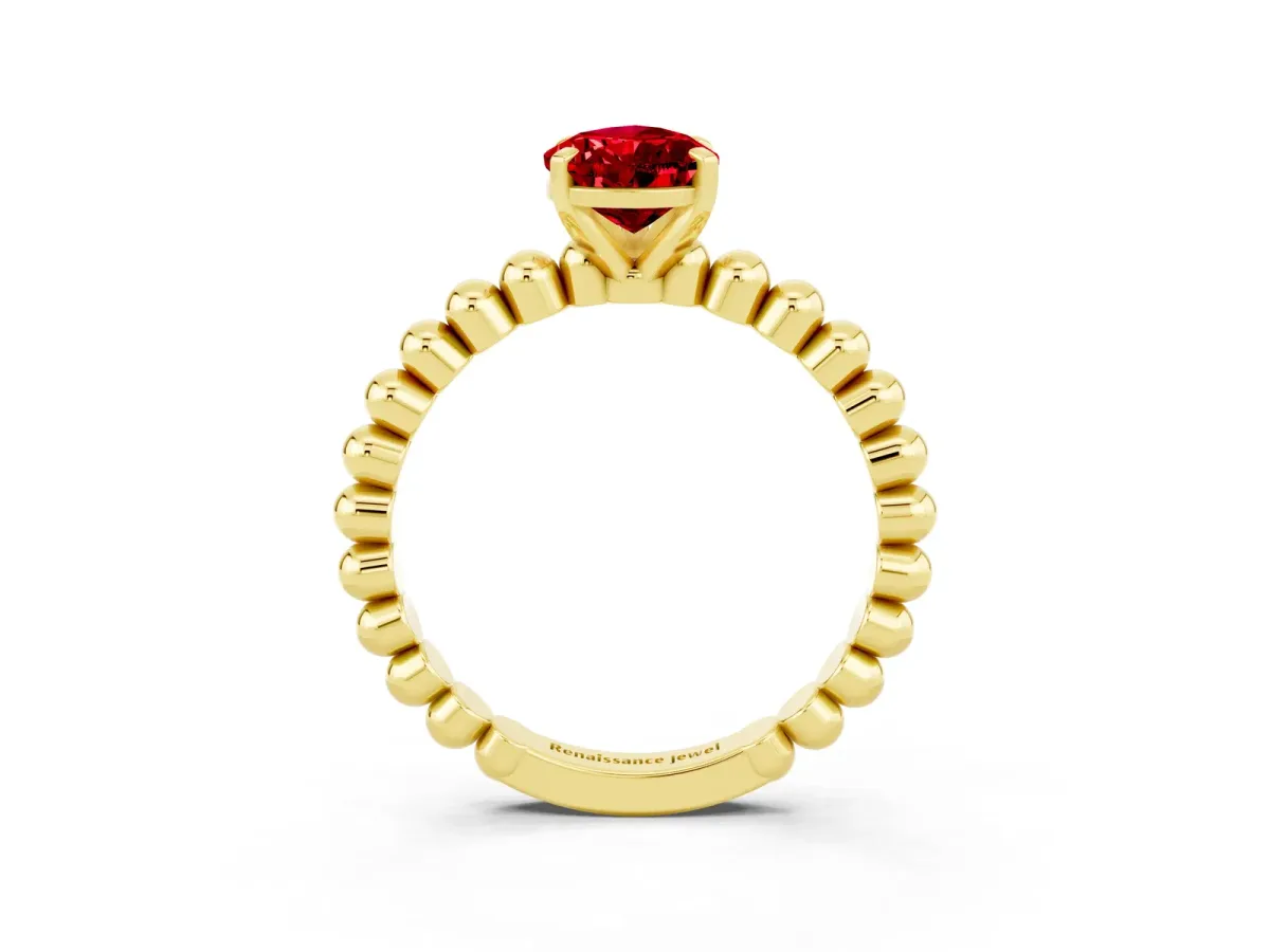 Pear Cut Ruby Solitaire Ring with Beaded Band and Prong Setting Yellow gold