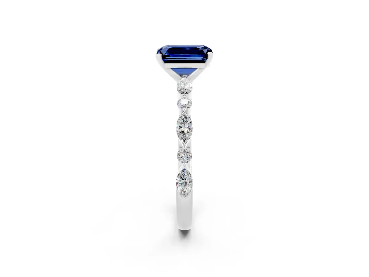 Emerald Cut Blue Sapphire Ring with Marquise and Round Side Stones and Four-Prong Setting Silver