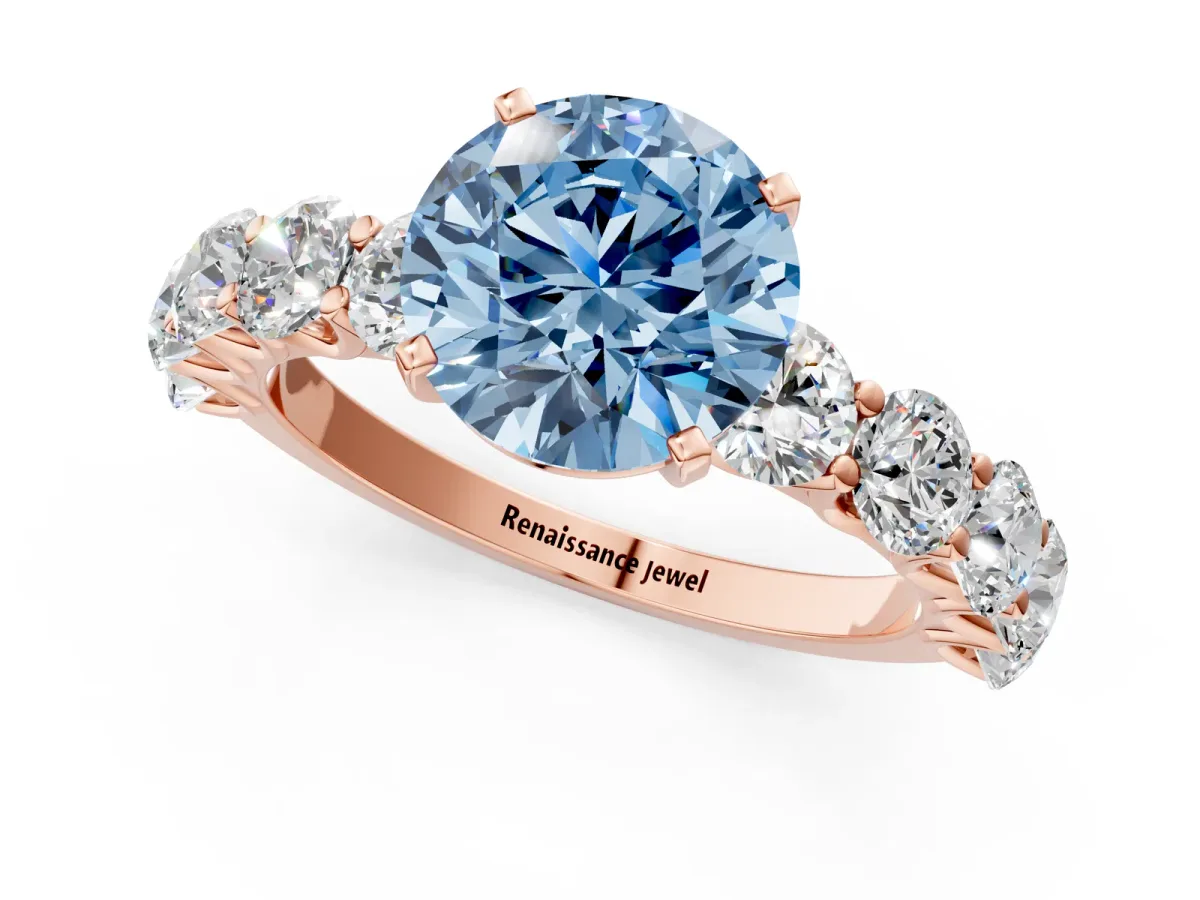 Fancy Blue Round Cut Diamond Prong Setting with Side Stones on a Pave Band Rose gold