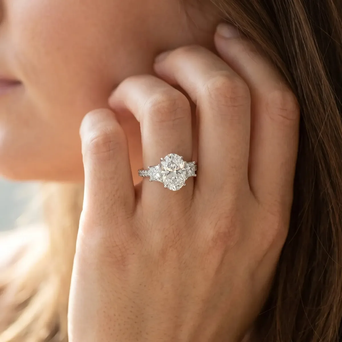 Three-Stone Oval Cut Cut Diamond Ring with Channel Set Band and Four-Prong Setting Platinum