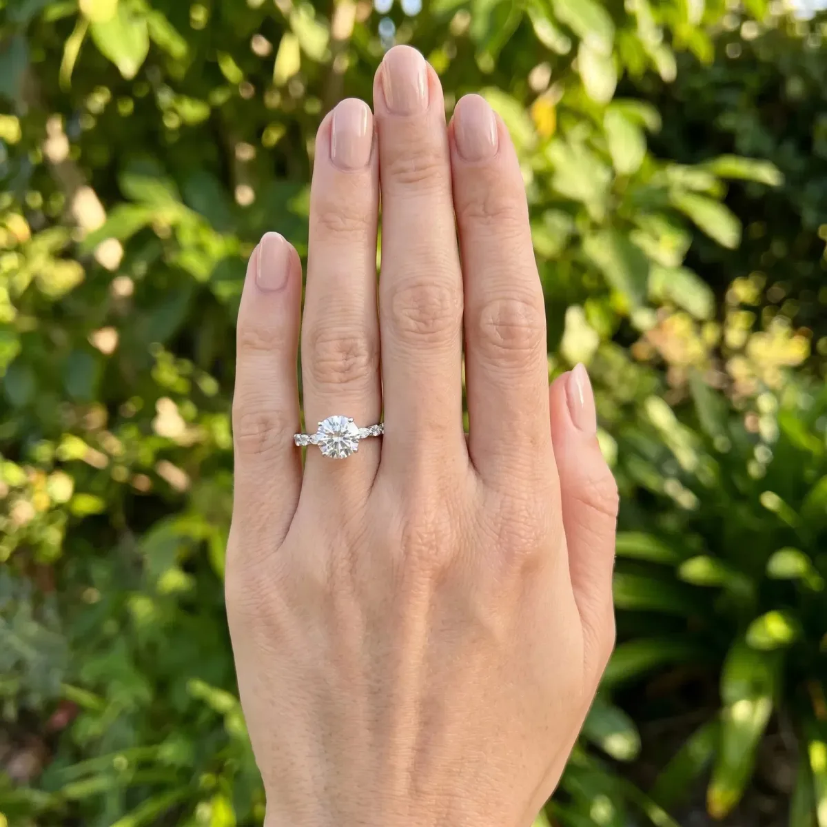 Round Cut Diamond Ring with Marquise and Round Side Stones and Four-Prong Setting Silver