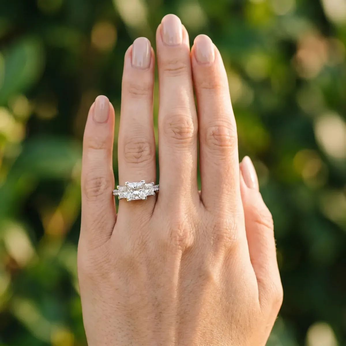 Three-Stone Princess Cut Cut Diamond Ring with Channel Set Band and Four-Prong Setting Platinum