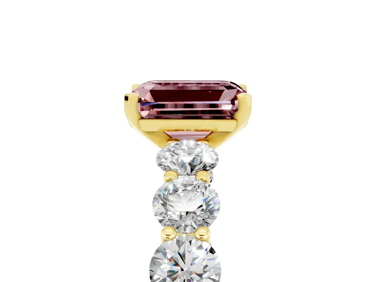 Emerald Cut Morganite Prong Setting with Side Stones on a Pave Band Yellow gold