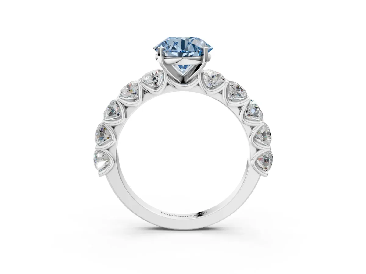 Fancy Blue Round Cut Diamond Prong Setting with Side Stones on a Pave Band Platinum