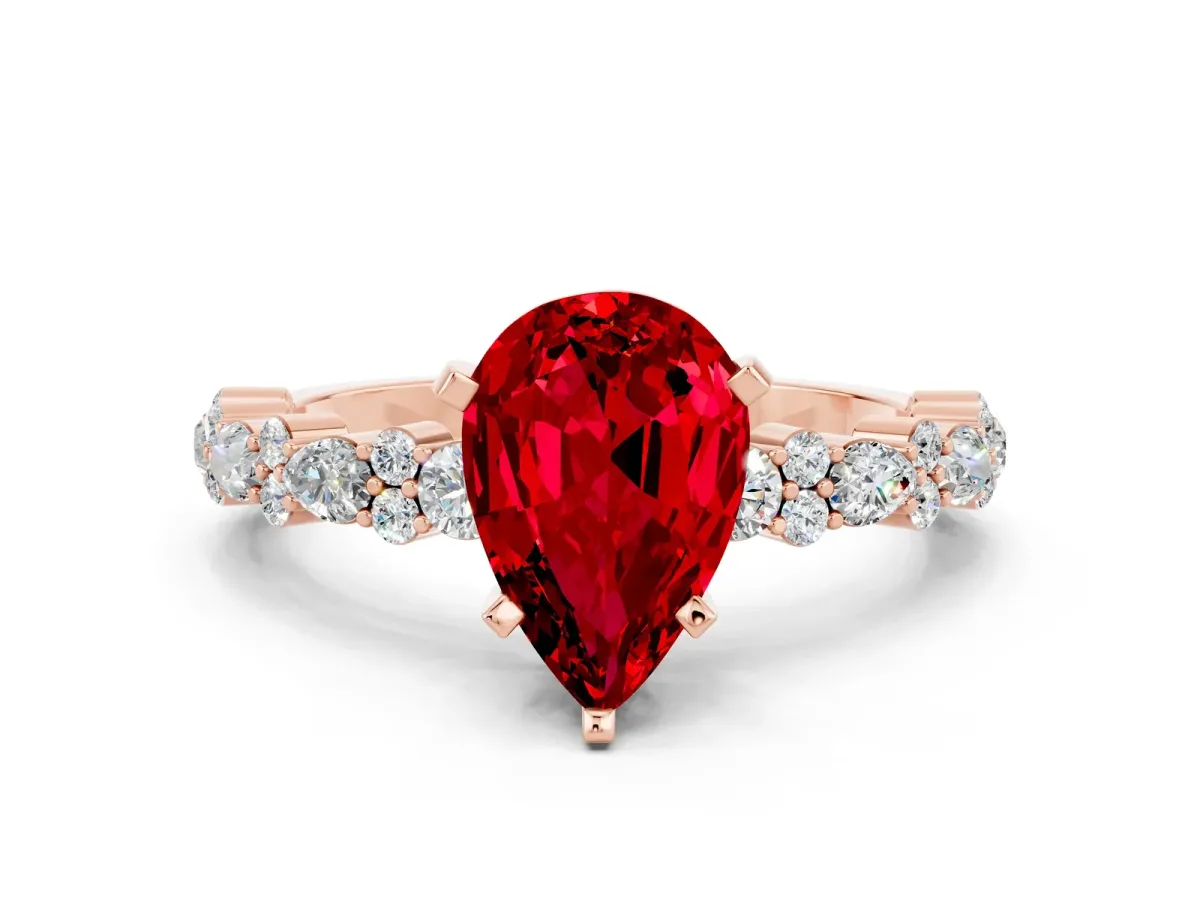 Pear Cut Ruby Side Stone Solitaire Ring with Round and Four-Prong Setting Rose gold