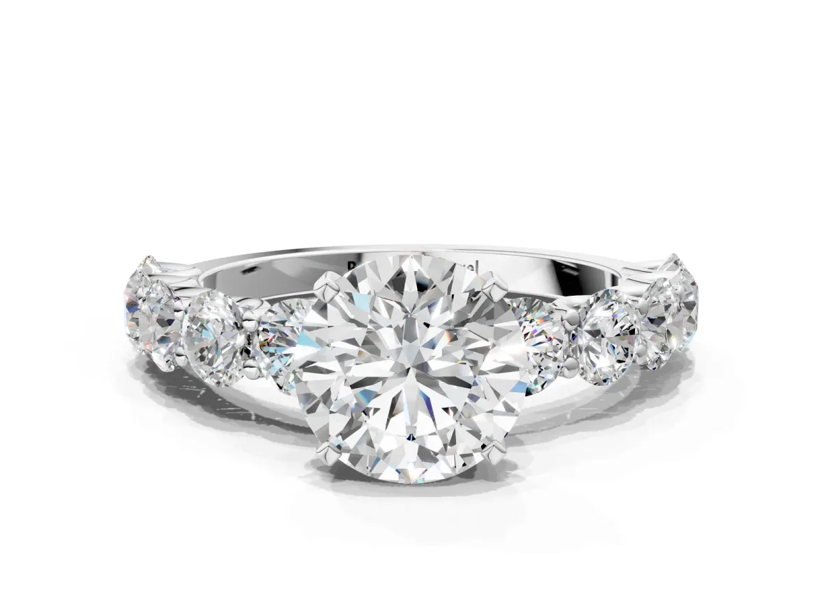 Round Cut Diamond Prong Setting with Side Stones on a Pave Band Platinum