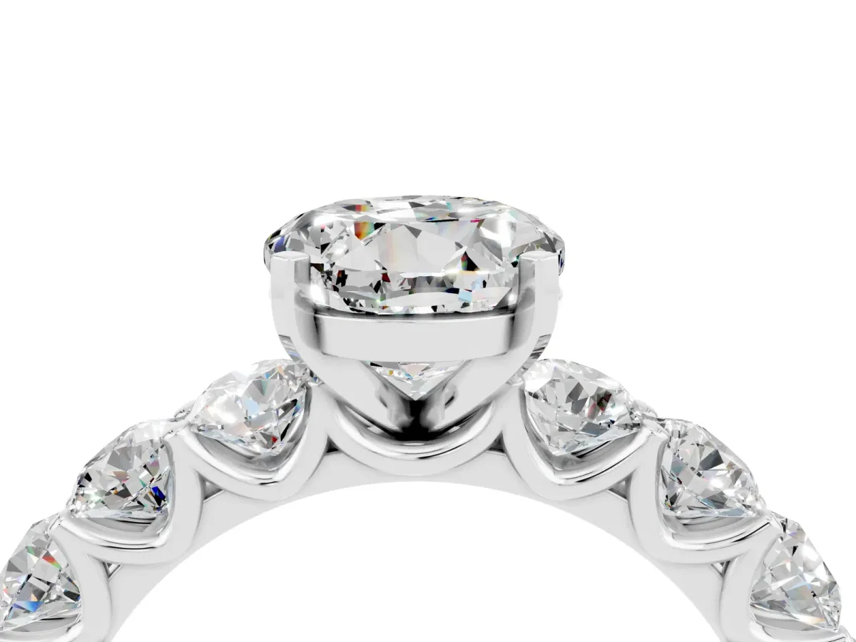 Round Cut Moissanite Prong Setting with Side Stones on a Pave Band Silver