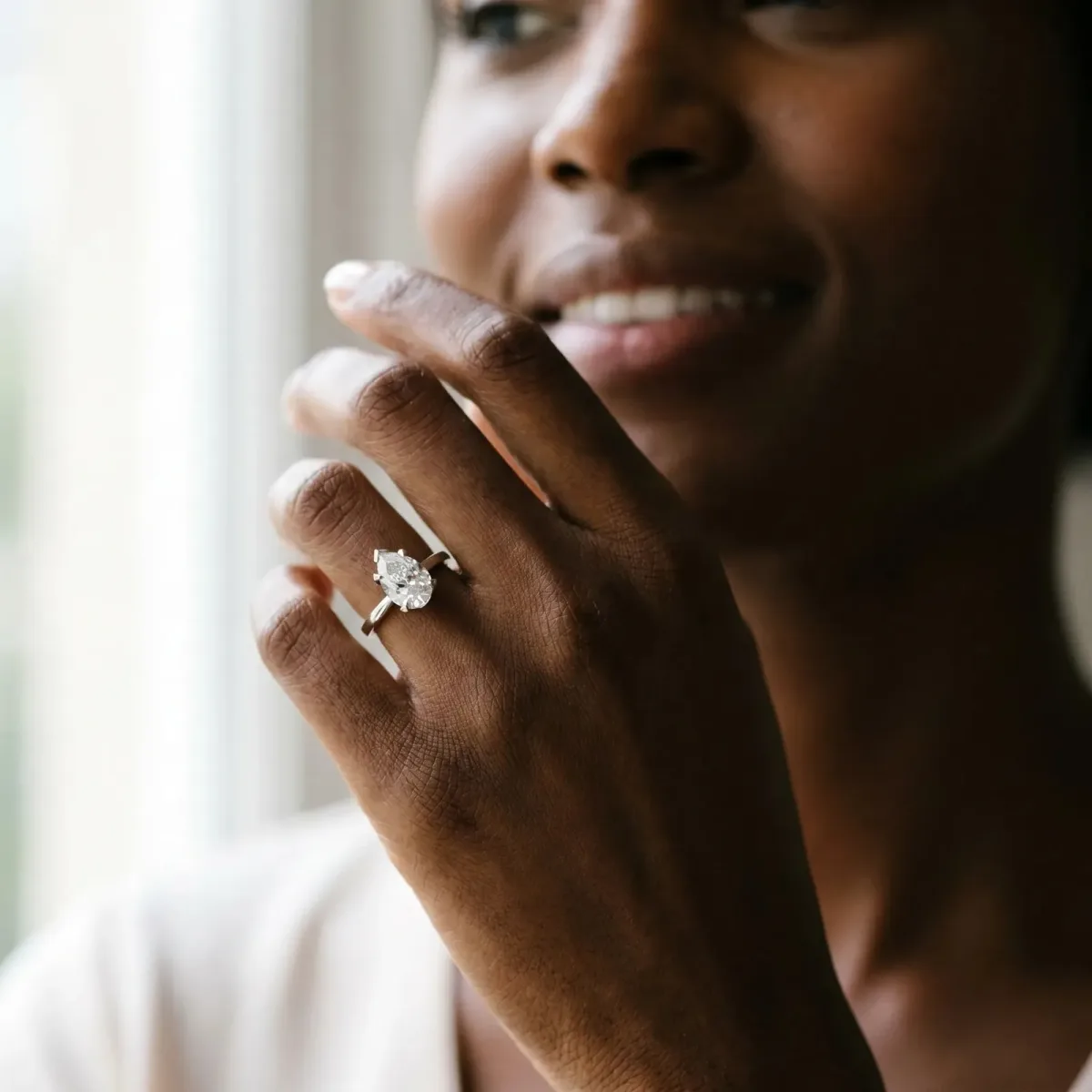 Pear Cut Diamond Solitaire Ring with Flower Prong Setting and Classic Band Silver