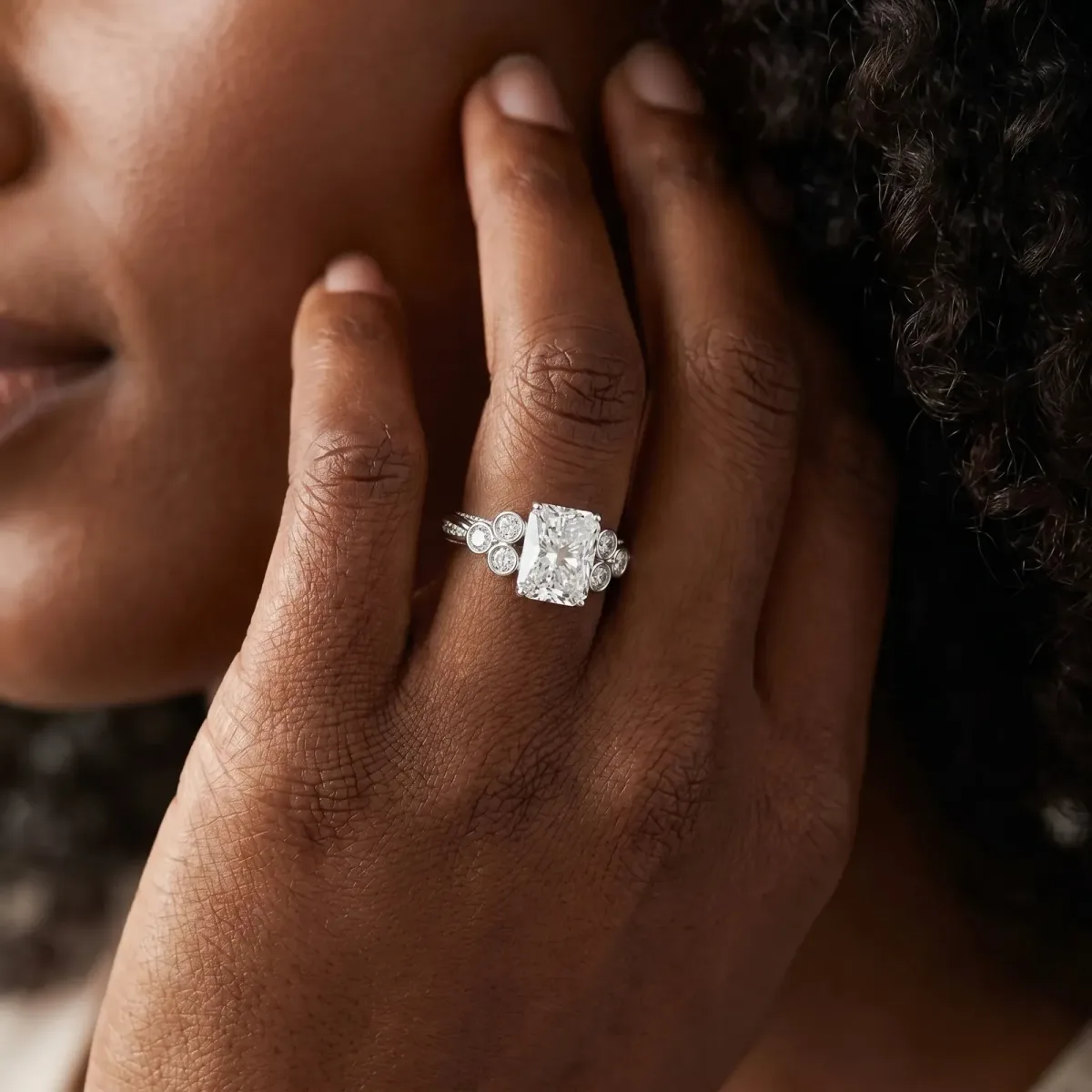 Radiant Cut Cut Diamond Engagement Ring with Bezel Set Round Side Stones and Prong Setting Platinum