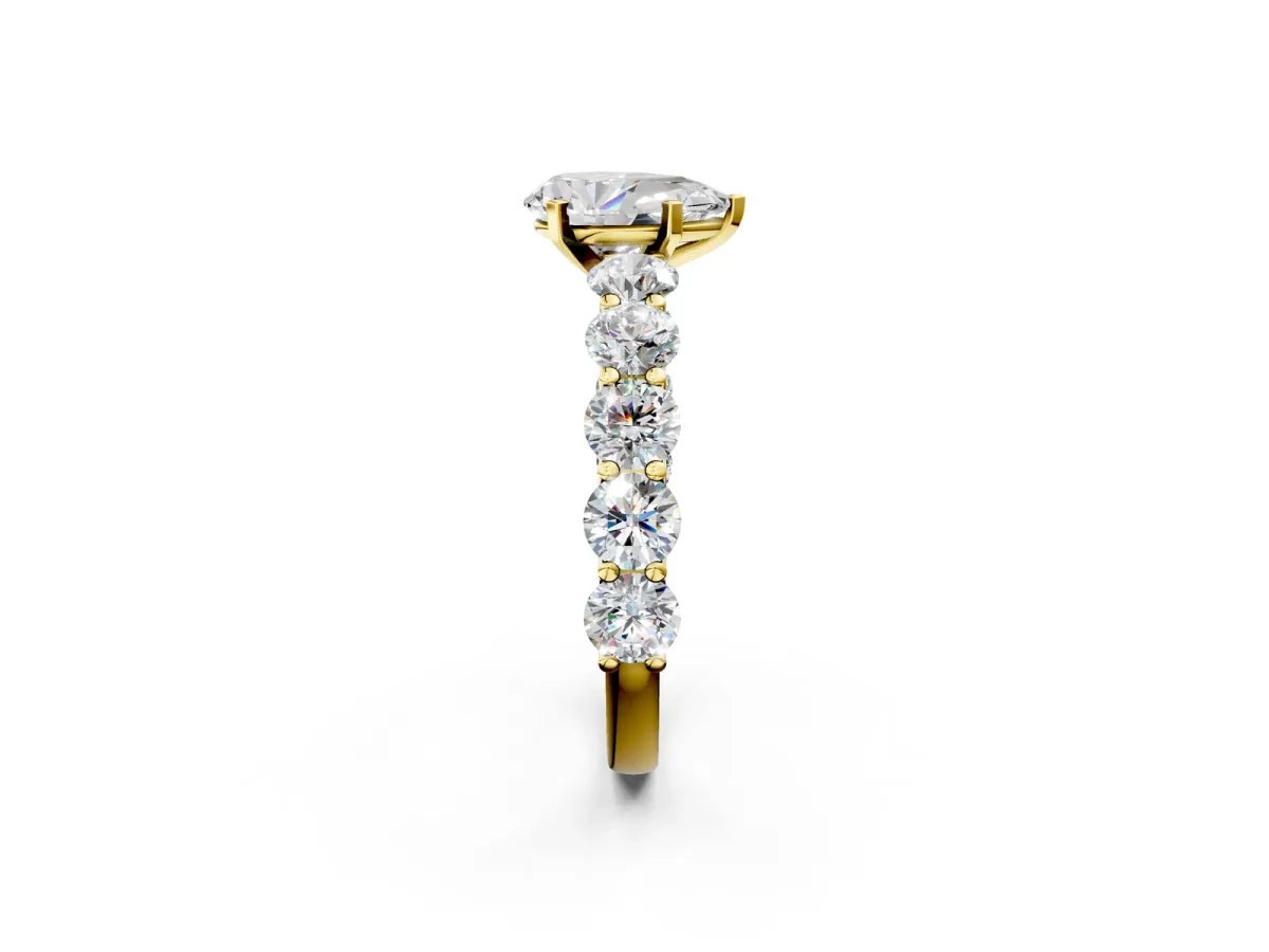 Pear Cut Diamond Prong Setting with Side Stones on a Pave Band Yellow gold