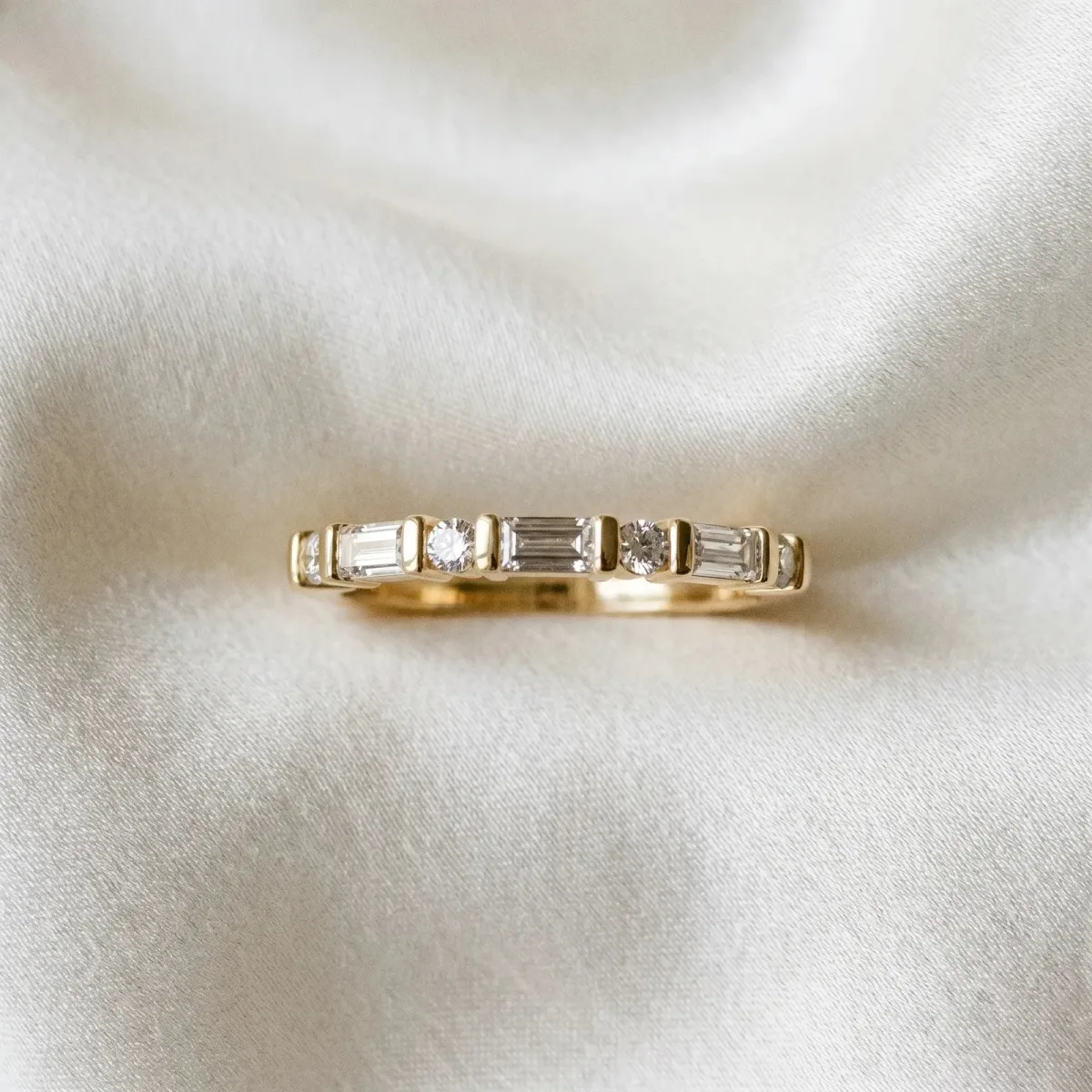 Baguette and Round Diamond Channel Set Half Eternity Band with Bar Prong Setting Yellow gold