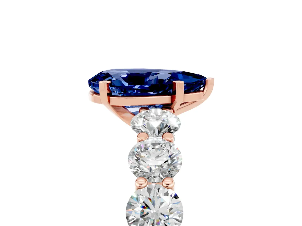 Pear Cut Blue Sapphire Prong Setting with Side Stones on a Pave Band Rose gold