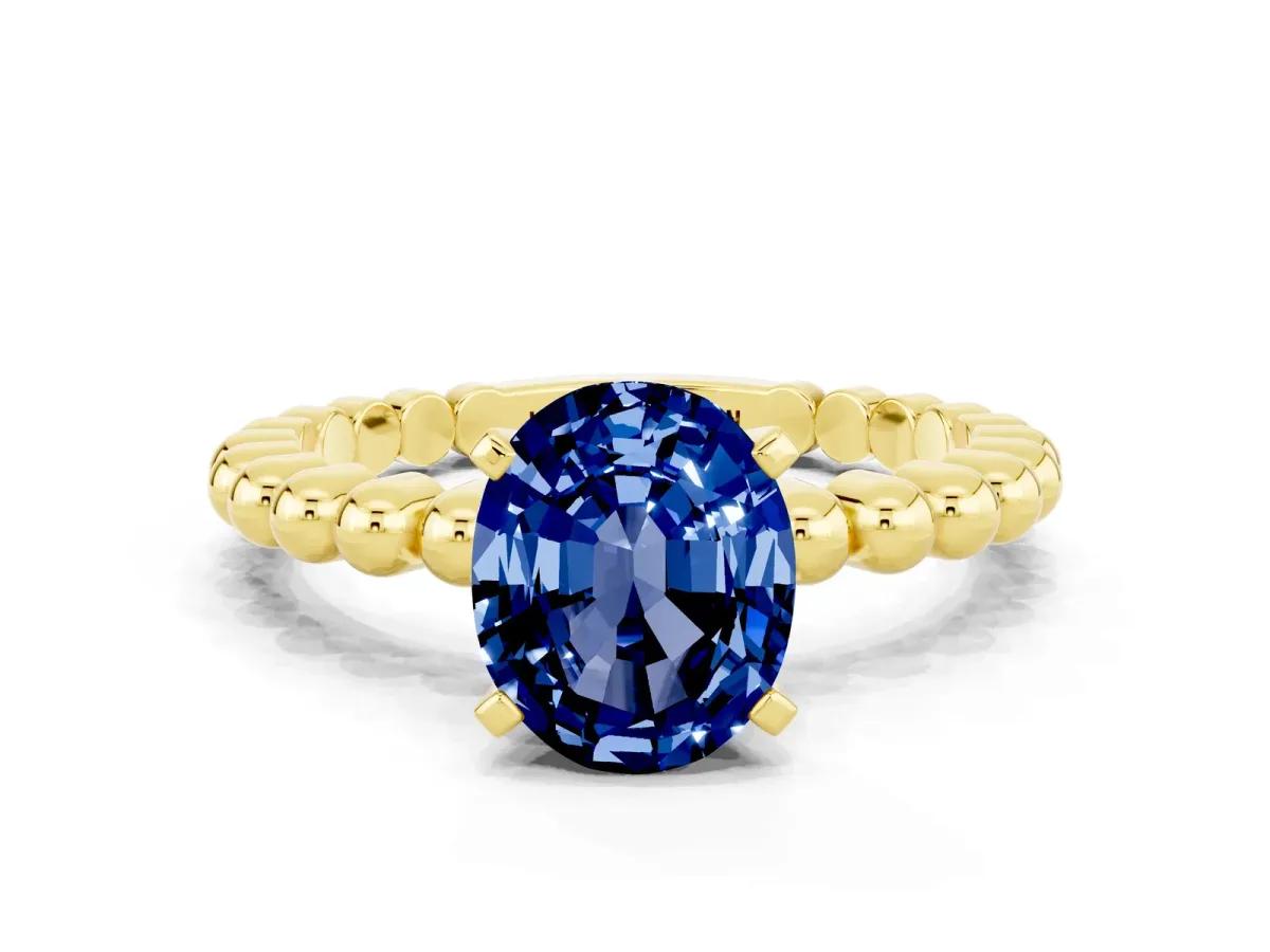 Oval Cut Blue Sapphire Solitaire Ring with Beaded Band and Prong Setting Yellow gold