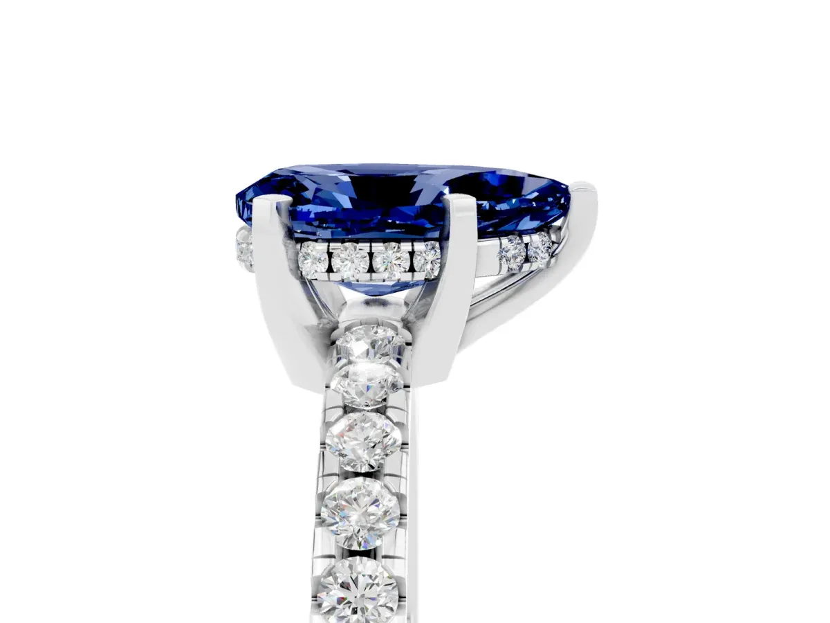 Pear Cut Blue Sapphire Solitaire Ring with Round Pavé Band and Four-Prong Setting Silver