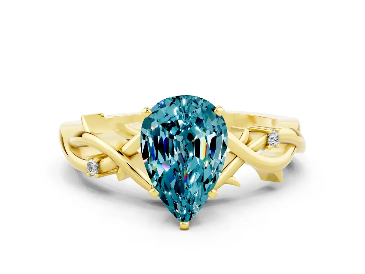 Pear Cut Blue Topaz Solitaire Ring with Twisted Band and Prong Setting Yellow gold