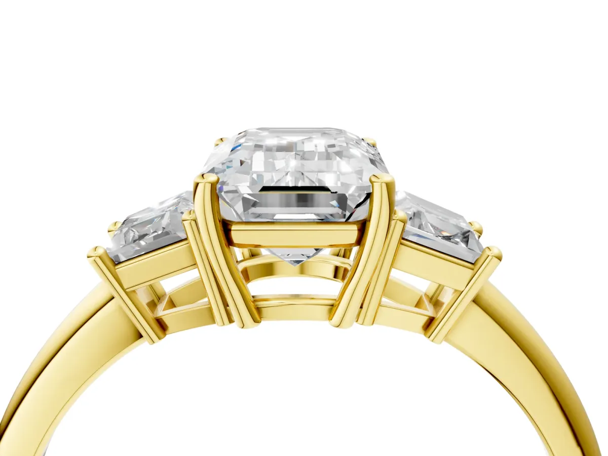Emerald Cut Diamond Three-Stone Ring with Trapezoid Side Stones and Prong Setting Yellow gold