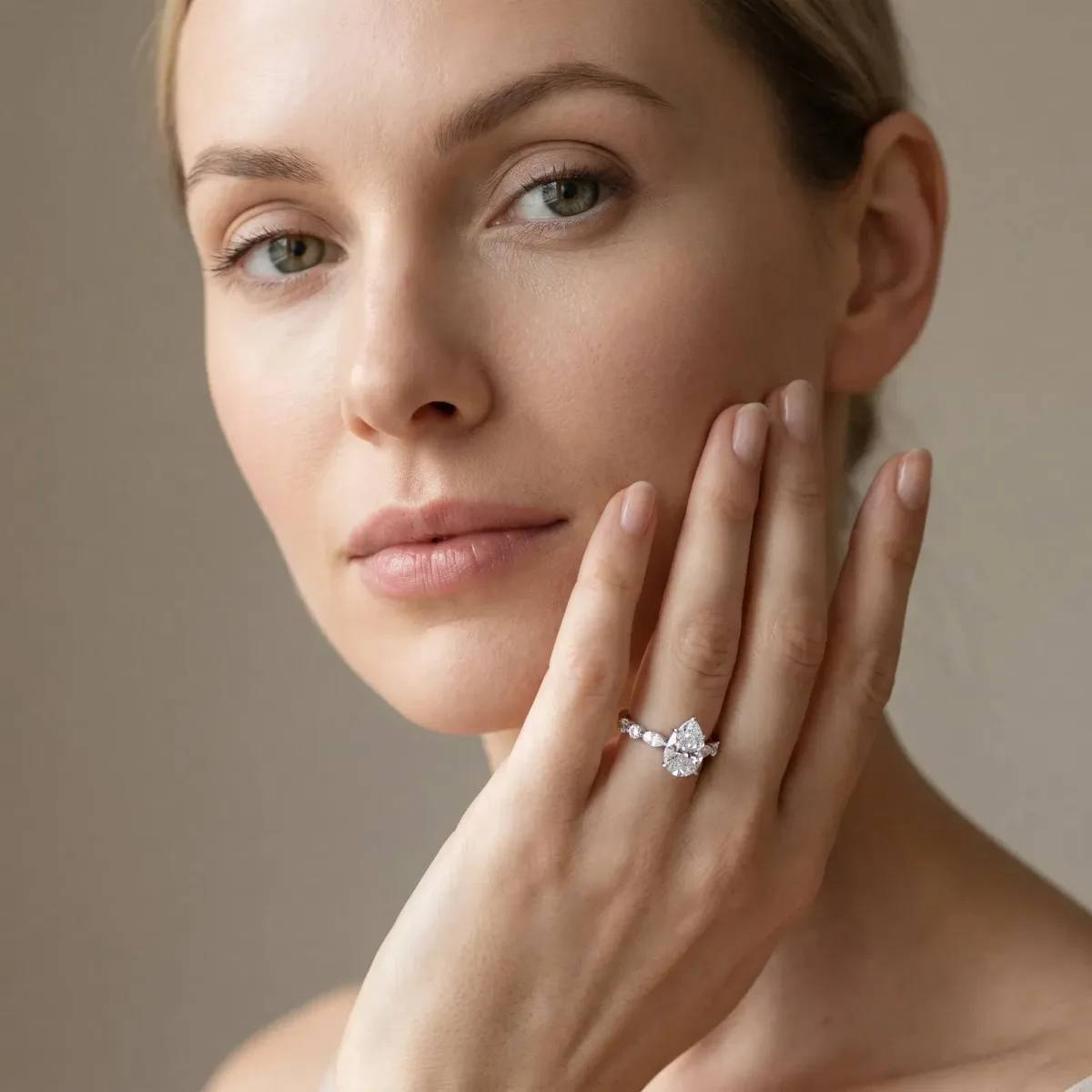Pear Cut Diamond Ring with Marquise and Round Side Stones and Four-Prong Setting Silver