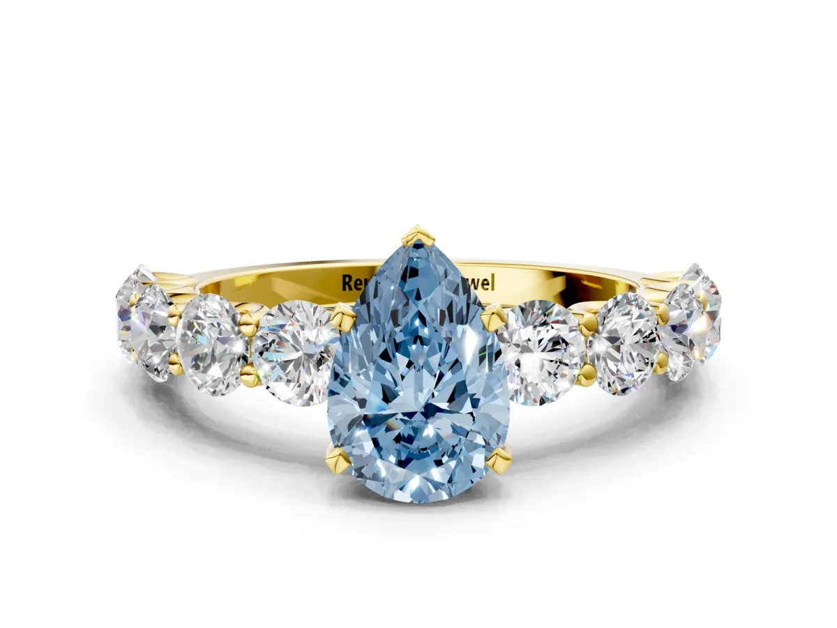 Fancy Blue Pear Cut Diamond Prong Setting with Side Stones on a Pave Band Yellow gold