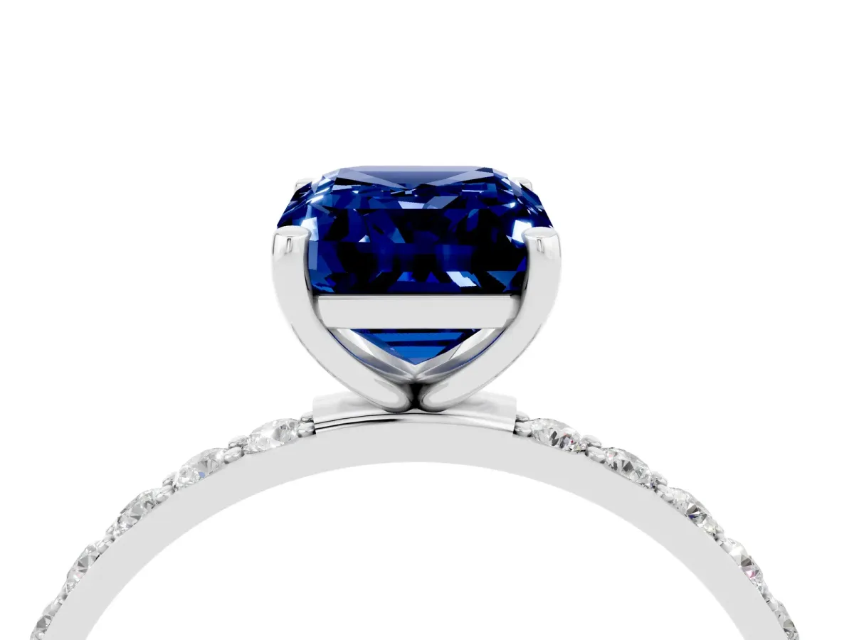 Emerald Cut Blue Sapphire Solitaire Ring with Round Pavé Band and Prong Setting Silver