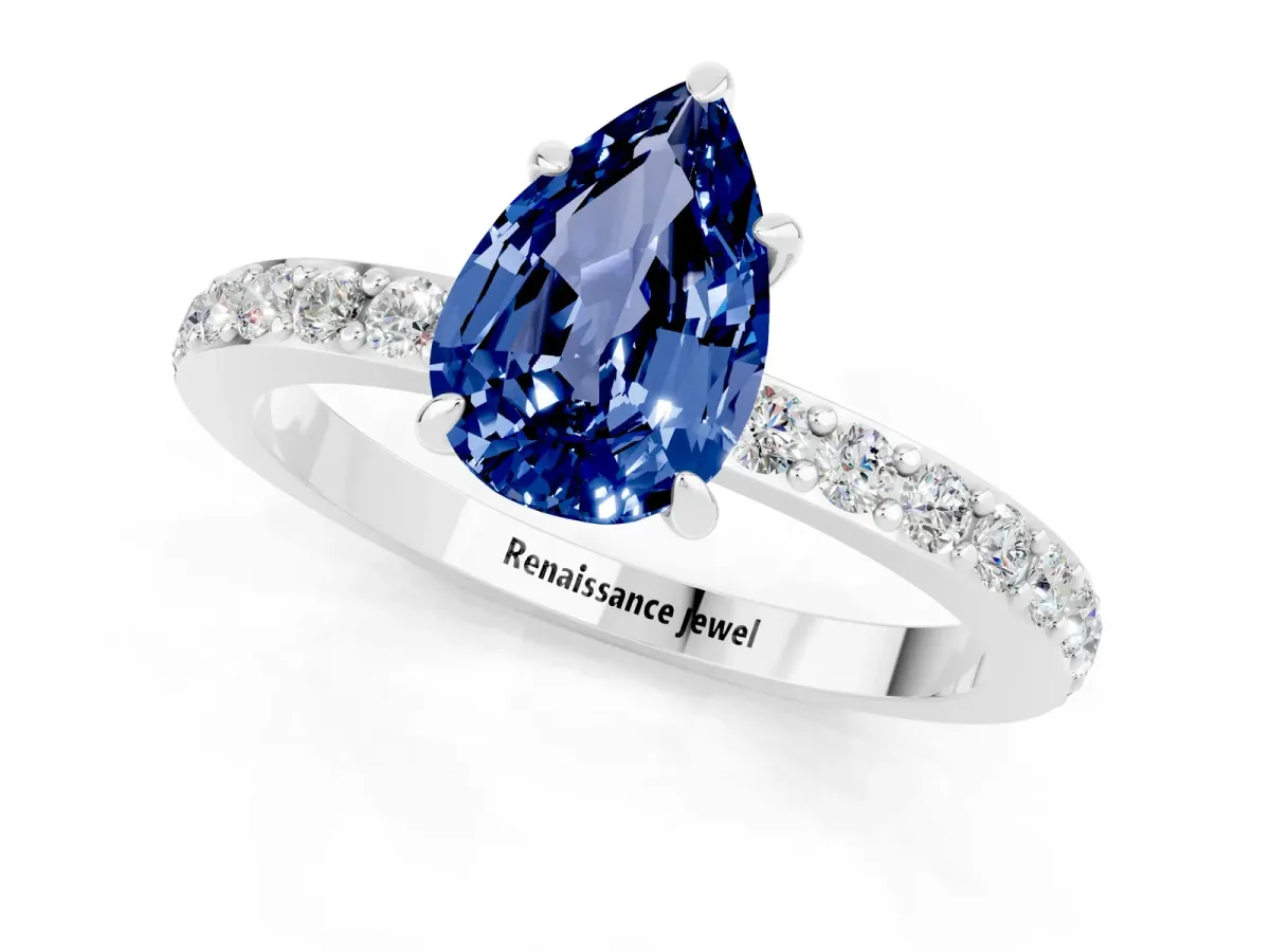 Pear Cut Blue Sapphire Solitaire Engagement Ring with Pavé Band and Four-Prong Setting Silver